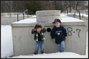 Kids In Front of a Tank